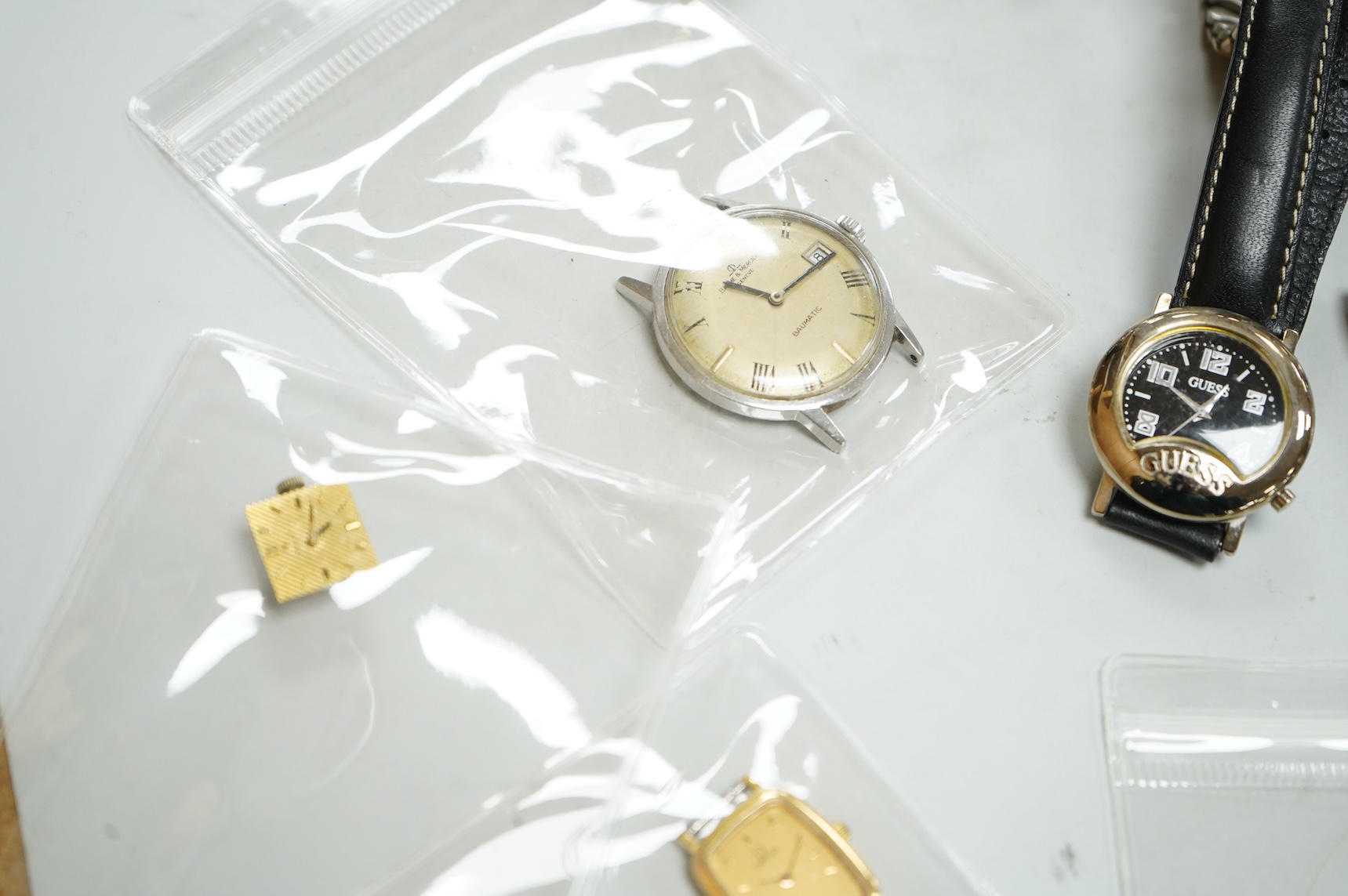 A small collection of assorted lady's and gentleman's wrist watches, including three Omega De Ville steel and gold plated quartz watches and wrist watches movements including Girard Perregaux.